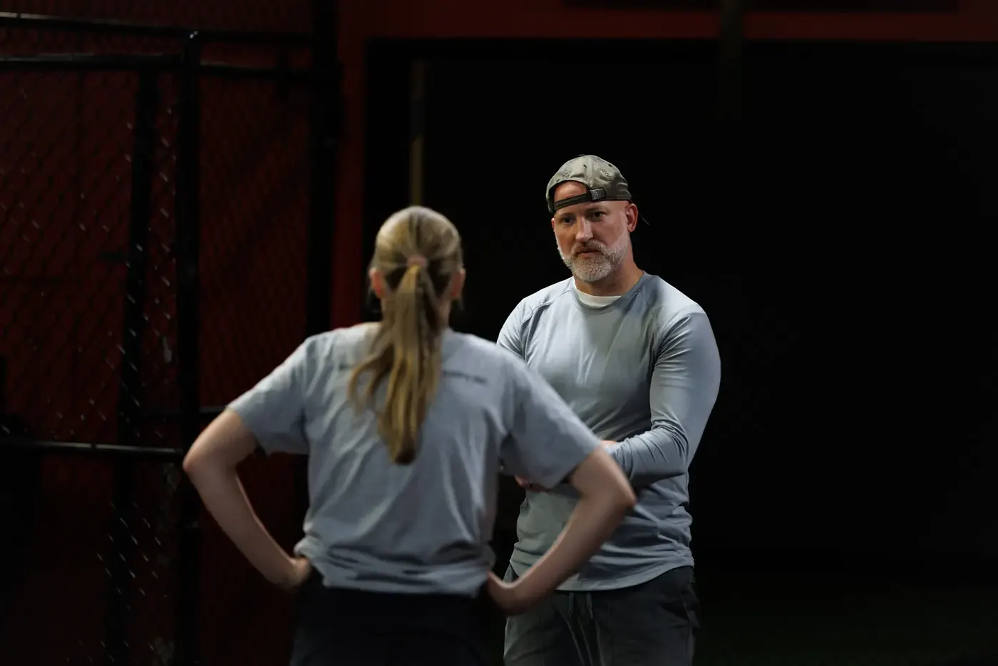 Coach Aaron talking with an athlete between sets