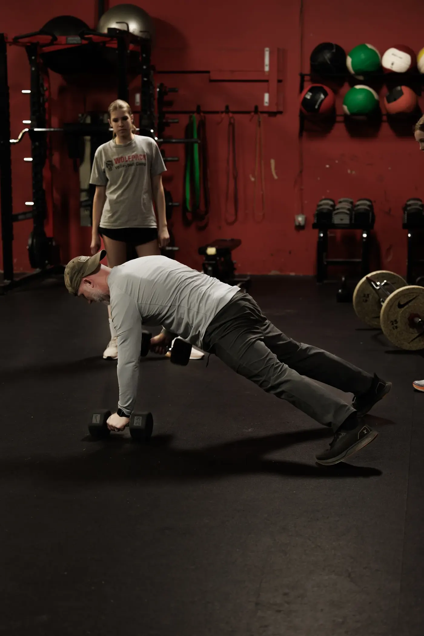 Coach Aaron demonstrating a plank row in the gym